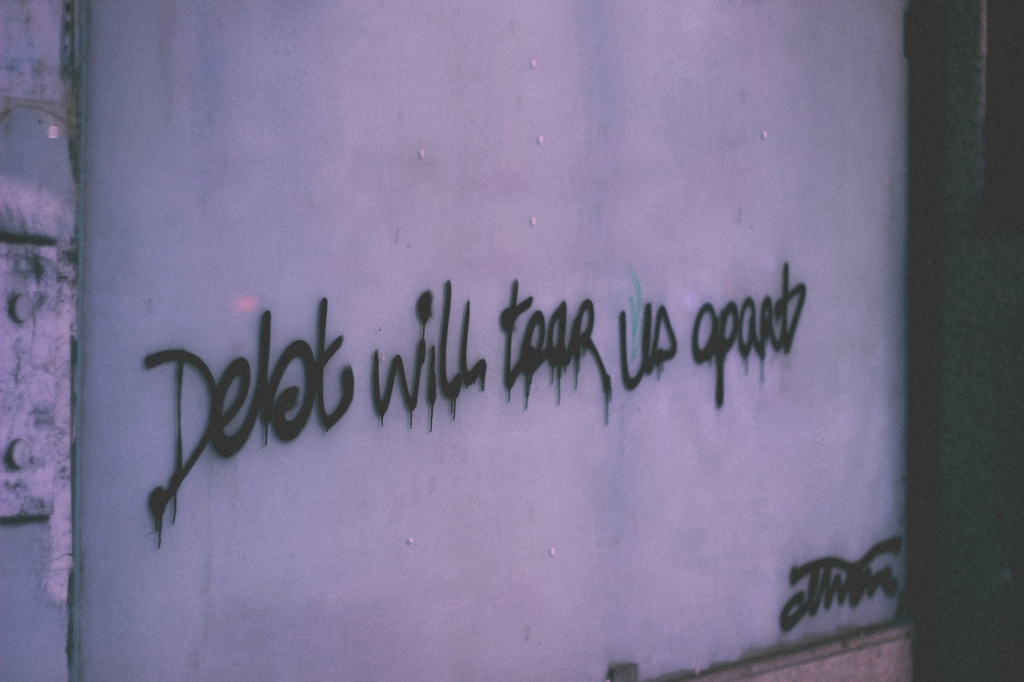 Debt will tear us apart, spray on wall